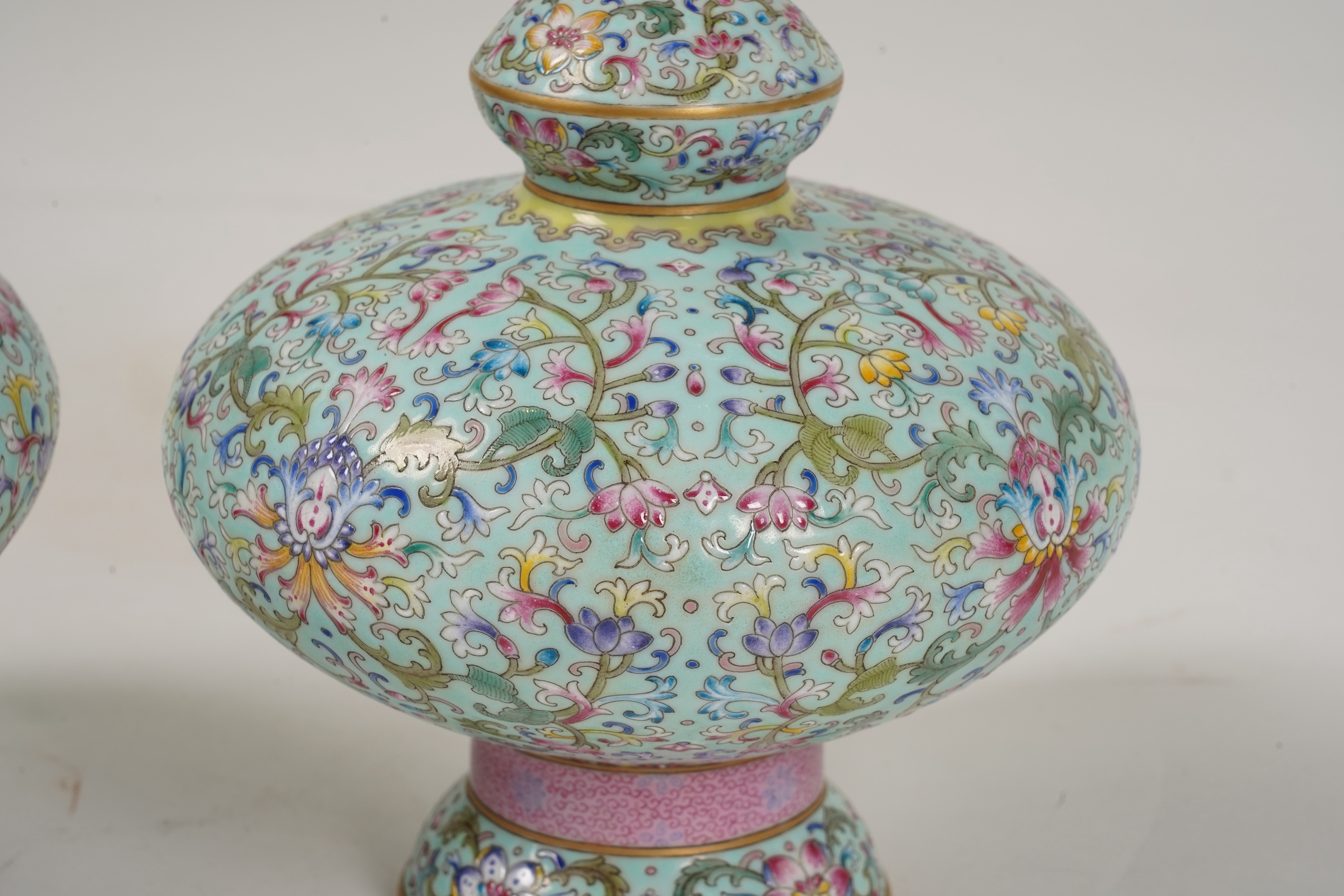 A pair of Chinese famille rose enamelled porcelain bottle vases, Qianlong seal mark to base but Republic Period